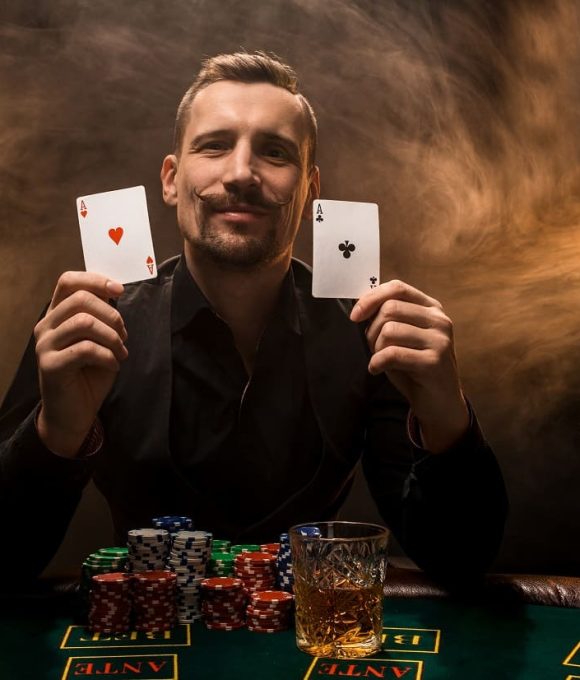 man-is-playing-poker-with-cigar-whiskey-man-show-two-cards-hand-winning-all-chips-table-with-thick-cigarette-smoke-concept-victory