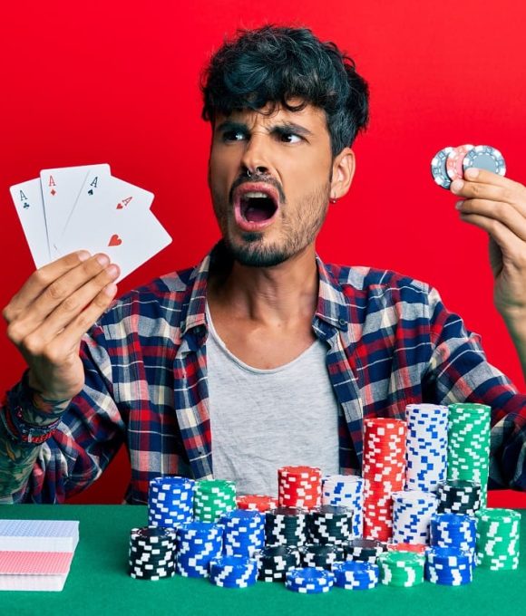 young-hispanic-man-playing-poker-holding-cards-casino-chips-angry-mad-screaming-frustrated-furious-shouting-with-anger-rage-aggressive-concept